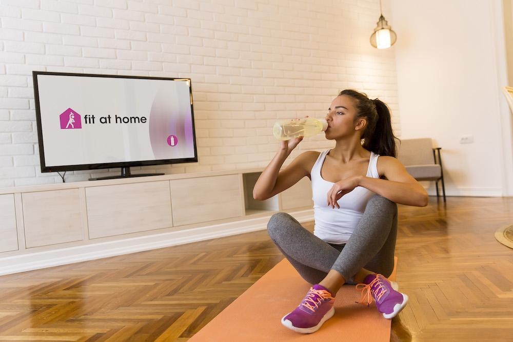 Woman drinking during home workout
